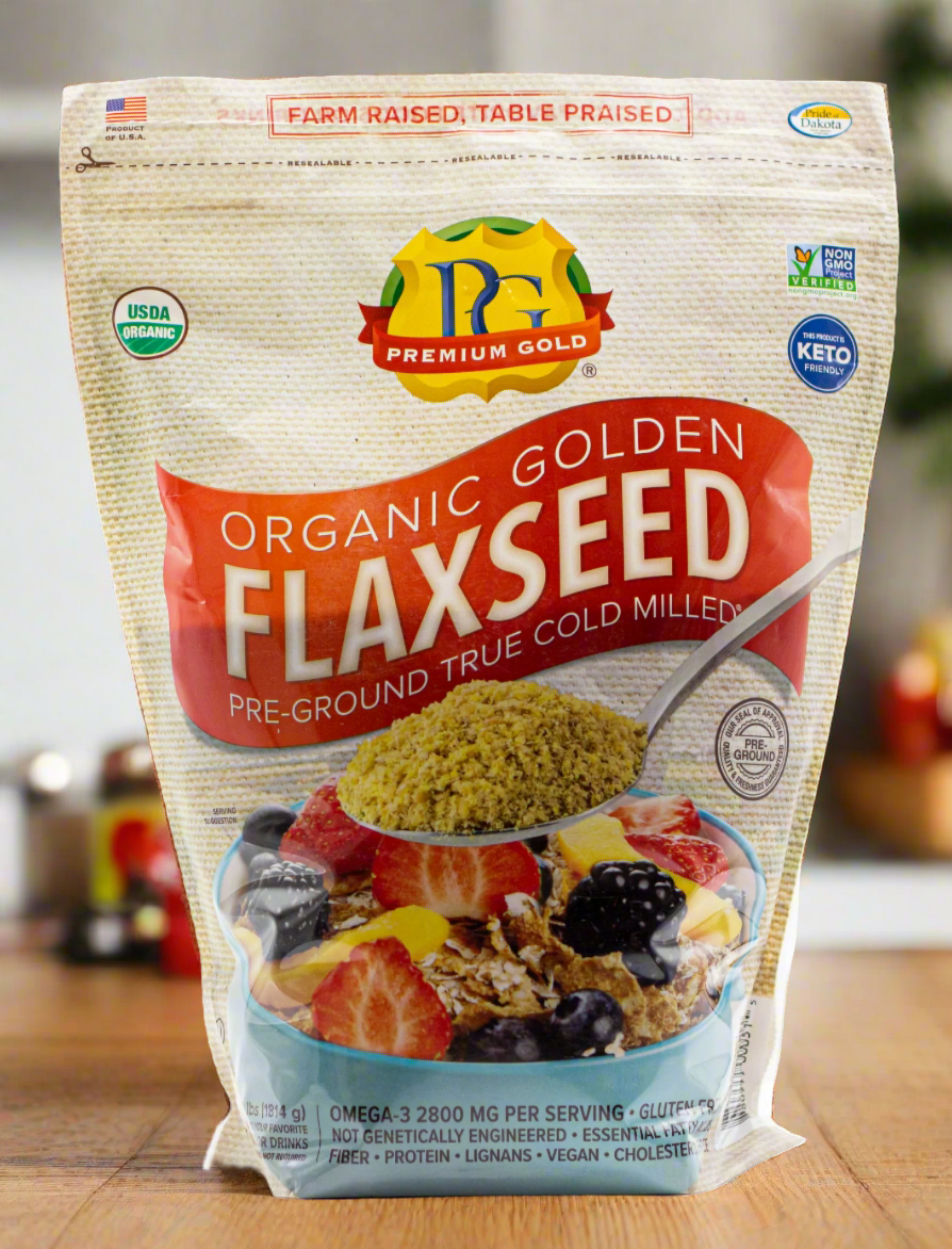 Two packages of Premium Gold Organic Golden Flaxseed with different designs on a white background