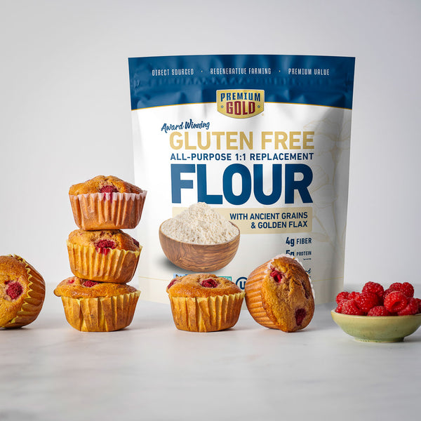 Bag of Premium Gold gluten-free flour with muffins and berries on a white background
