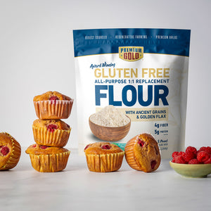 Bag of Premium Gold Gluten Free All-Purpose Replacement Flour with muffins and raspberries on a light background