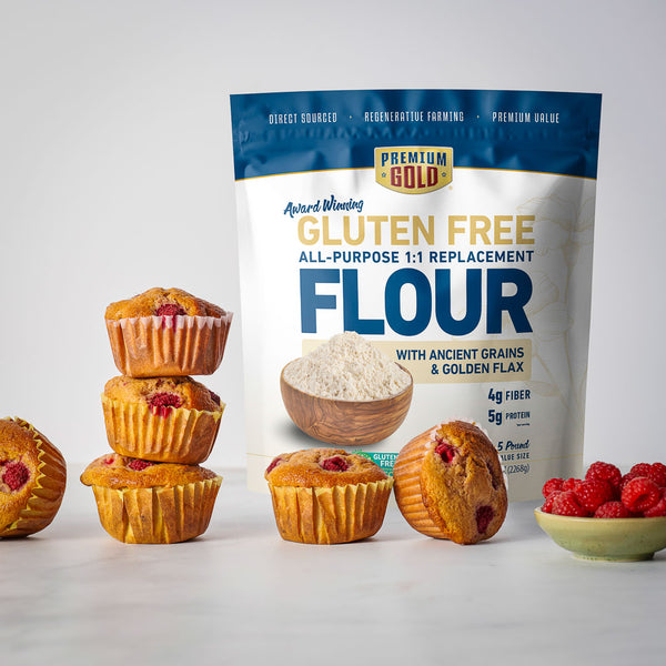 Bag of Premium Gold Gluten Free All-Purpose Replacement Flour with muffins and raspberries on a light background