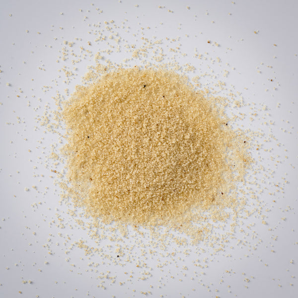 Pile of Premium Gold Brand whole white fonio on a white background